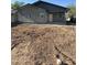 An exterior shot of a cozy home with stucco walls and a freshly cleared yard at 1110 E Pierce St, Phoenix, AZ 85006