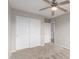 This cozy bedroom features neutral walls, tan carpet, and a ceiling fan, offering a serene space at 11132 W Mariposa Dr, Phoenix, AZ 85037