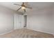 This bedroom features neutral walls, tan carpet, a ceiling fan, and a closet offering ample storage at 11132 W Mariposa Dr, Phoenix, AZ 85037