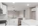 Bright kitchen with white cabinets, stainless steel appliances, and eat-in bar at 11132 W Mariposa Dr, Phoenix, AZ 85037