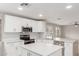 A modern kitchen boasts white cabinetry, stainless steel appliances, and a stylish backsplash at 11132 W Mariposa Dr, Phoenix, AZ 85037