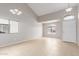 Open-concept living room with lots of natural light and tile flooring at 11132 W Mariposa Dr, Phoenix, AZ 85037