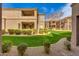 Scenic view of the building's backyard featuring a lush green lawn, mature trees and desert landscaping at 11680 E Sahuaro Dr # 1059, Scottsdale, AZ 85259