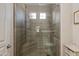 Modern bathroom with glass enclosed shower, two windows, with horizontally laid light brown tile at 11680 E Sahuaro Dr # 1059, Scottsdale, AZ 85259