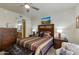 Bright and inviting bedroom with a colorful quilt, wood furniture, and ensuite bathroom at 11680 E Sahuaro Dr # 1059, Scottsdale, AZ 85259