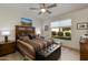 Warm bedroom with a colorful quilt on the bed, wood furniture, and a bright window view at 11680 E Sahuaro Dr # 1059, Scottsdale, AZ 85259