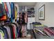 Organized walk-in closet with shelving, drawers, rods, and baskets filled with clothing at 11680 E Sahuaro Dr # 1059, Scottsdale, AZ 85259