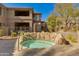 Relaxing community hot tub is surrounded by rock features and landscaping, providing a tranquil escape for residents at 11680 E Sahuaro Dr # 1059, Scottsdale, AZ 85259