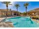Stunning community pool with palm trees, rock features, and a cabana, offering a perfect setting for relaxation and recreation at 11680 E Sahuaro Dr # 1059, Scottsdale, AZ 85259