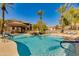 Inviting community pool surrounded by palm trees, a cabana, and a waterfall, offering a resort-like atmosphere for residents at 11680 E Sahuaro Dr # 1059, Scottsdale, AZ 85259