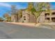 Well-maintained building exterior with mature trees, parking and easy access to upper floor units at 11680 E Sahuaro Dr # 1059, Scottsdale, AZ 85259