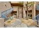 Well-landscaped complex exterior with gravel, mature trees and staircases to upper units at 11680 E Sahuaro Dr # 1059, Scottsdale, AZ 85259