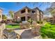 Outdoor grilling area with stone accents near multi-story condo buildings, a great space to relax at 11680 E Sahuaro Dr # 1059, Scottsdale, AZ 85259