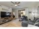 Comfortable living room featuring a ceiling fan, wood-look tile flooring, and sliding glass door to outdoor patio at 11680 E Sahuaro Dr # 1059, Scottsdale, AZ 85259