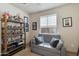 Comfortable living room with gray sofa, throw pillows, and vintage decor at 11680 E Sahuaro Dr # 1059, Scottsdale, AZ 85259