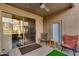 Inviting outdoor patio featuring tiled flooring, a ceiling fan, and comfortable seating arrangement at 11680 E Sahuaro Dr # 1059, Scottsdale, AZ 85259