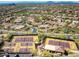 Aerial view of desert community featuring tennis courts, lush landscaping, and scenic mountain views at 12366 N 129Th St, Scottsdale, AZ 85259