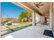 Expansive backyard with covered patio, artificial turf, and desert landscaping at 12366 N 129Th St, Scottsdale, AZ 85259