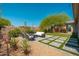 This backyard features an outdoor seating area, desert landscaping and beautiful hardscaping at 12366 N 129Th St, Scottsdale, AZ 85259