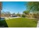Serene backyard with lush artificial turf, desert landscaping, and mountain views at 12366 N 129Th St, Scottsdale, AZ 85259