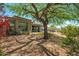 Desert-landscaped backyard with a mature tree and artificial turf at 12366 N 129Th St, Scottsdale, AZ 85259