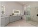 Bright bathroom with a double vanity, a stand alone tub and frameless glass shower at 12366 N 129Th St, Scottsdale, AZ 85259