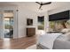 Bright bedroom featuring a wooden dresser, a sliding glass door, and natural light from black-trimmed windows at 12366 N 129Th St, Scottsdale, AZ 85259