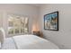 Bright bedroom featuring hardwood floors, a plantation shutter window, and tasteful decor at 12366 N 129Th St, Scottsdale, AZ 85259