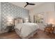 Cozy bedroom with patterned wallpaper, hardwood floors, and a bright window with plantation shutters at 12366 N 129Th St, Scottsdale, AZ 85259