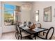 Bright dining room with a modern chandelier, dark table, and neutral-toned chairs at 12366 N 129Th St, Scottsdale, AZ 85259