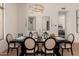 Inviting dining room boasts a dark wood table, chandelier, and decor mirrors at 12366 N 129Th St, Scottsdale, AZ 85259