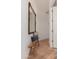 Inviting hallway with bench seat, rustic wood floors, mirror and decor at 12366 N 129Th St, Scottsdale, AZ 85259