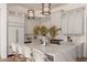 Bright kitchen features light gray cabinetry, quartz countertops, and an island with seating at 12366 N 129Th St, Scottsdale, AZ 85259