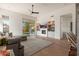 Bright living room with a gray sectional couch, fireplace, wood floors, and sliding glass doors to the backyard at 12366 N 129Th St, Scottsdale, AZ 85259