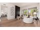Modern living room boasts a dark tiled fireplace, wood floors, and ample natural light at 12366 N 129Th St, Scottsdale, AZ 85259