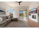 Comfortable living room with sliding glass doors to backyard, built-in fireplace, and hardwood floors at 12366 N 129Th St, Scottsdale, AZ 85259