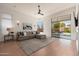 Spacious living room featuring wood floors, a comfortable sofa, and a sliding door to the patio at 12366 N 129Th St, Scottsdale, AZ 85259