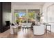 Contemporary living room with a black fireplace, wood floors, and stylish furnishings at 12366 N 129Th St, Scottsdale, AZ 85259