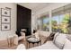 Cozy living room features a black fireplace, wood floors, and a picturesque window view at 12366 N 129Th St, Scottsdale, AZ 85259