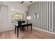 Bright office featuring a wooden desk, hardwood floors, and a bright window with plantation shutters at 12366 N 129Th St, Scottsdale, AZ 85259