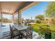 Covered patio area overlooking the manicured backyard with seating and dining areas at 12366 N 129Th St, Scottsdale, AZ 85259
