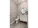 Stylish powder room featuring gray patterned wallpaper and modern fixtures at 12366 N 129Th St, Scottsdale, AZ 85259