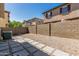 An enclosed backyard features a stone paver path and gravel at 1265 S Aaron -- # 271, Mesa, AZ 85209