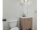 Half bathroom features a modern vanity with stylish mirror, lighting and fixtures, and updated toilet at 1265 S Aaron -- # 271, Mesa, AZ 85209