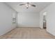 Bright bedroom featuring neutral carpet, ceiling fan, and ensuite bathroom access for added convenience at 1265 S Aaron -- # 271, Mesa, AZ 85209