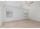 Spacious bedroom with bright, neutral walls, carpet, and natural light from two windows at 1265 S Aaron -- # 271, Mesa, AZ 85209