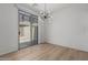 Cozy dining room featuring wood flooring, a modern light fixture, and sliding glass doors to the backyard at 1265 S Aaron -- # 271, Mesa, AZ 85209