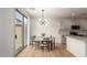 A spacious dining room features modern lighting and a sliding glass door to the outdoor patio at 1265 S Aaron -- # 271, Mesa, AZ 85209