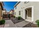 Charming home featuring a walkway leading to an arched doorway and neatly landscaped front yard at 1265 S Aaron -- # 271, Mesa, AZ 85209