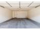 A clean, spacious garage with a gray concrete floor and white walls at 1265 S Aaron -- # 271, Mesa, AZ 85209